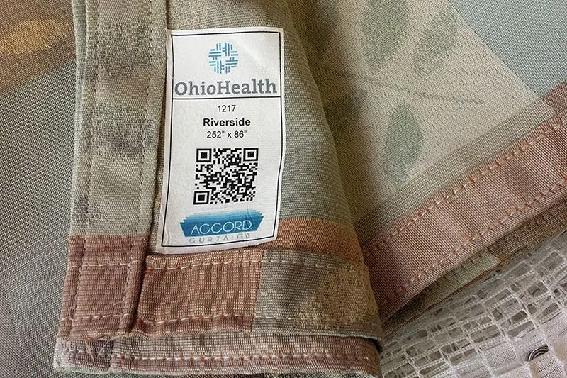 Woven Accord curtain label with a QR code reading OhioHealth, 1217 Riverside, 252 x 86 inches